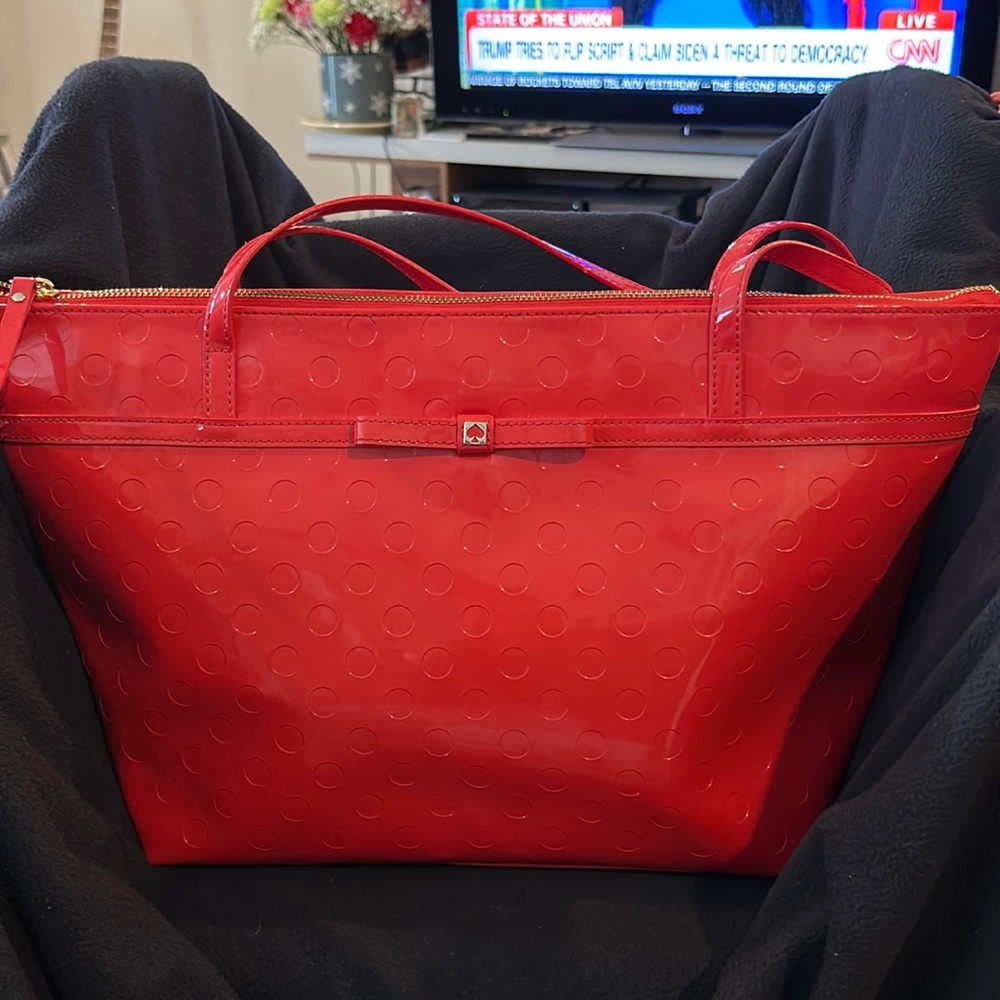 Kate Spade, red shoulder bag, accent on the front with a spade in a vinyl bow